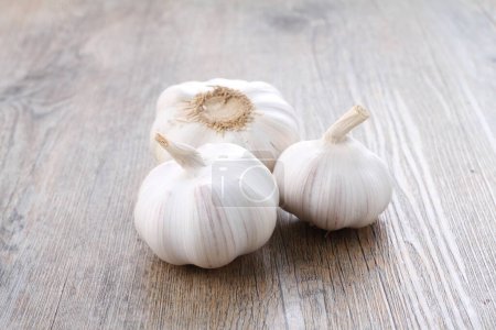 Photo for Garlic cloves in a wooden bowl - Royalty Free Image