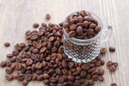 Photo for Coffee beans in a cup on a wooden background - Royalty Free Image