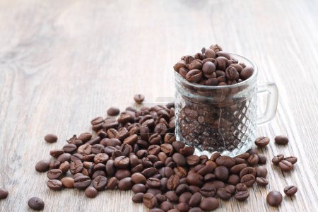 Photo for Coffee beans in glass jar on wooden table with copy space - Royalty Free Image
