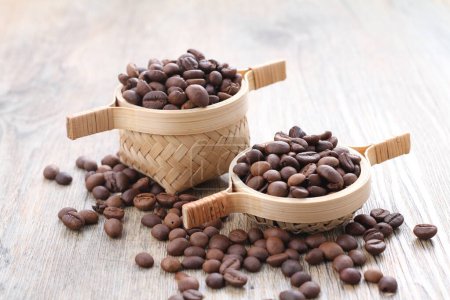 Photo for Coffee beans with a cup on a wooden background. - Royalty Free Image