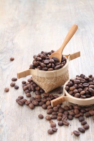 Photo for Coffee beans with wooden spoon, on wood background - Royalty Free Image