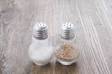 Photo for Salt and pepper on wooden background - Royalty Free Image