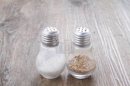Photo for Salt pepper and spices on wooden background - Royalty Free Image