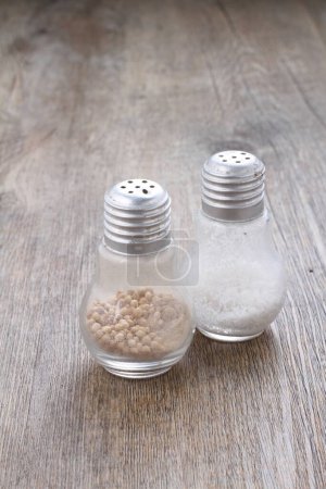 Photo for Salt pepper on wooden background - Royalty Free Image