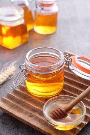 Photo for Pure honey in a glass jar - Royalty Free Image