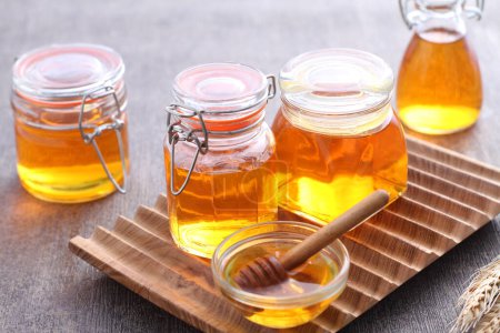 Photo for Pure honey in a glass jar - Royalty Free Image