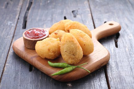 Photo for Comro is a typical Sundanese fritter. Comro is made from grated cassava which is shaped round or oval and filled with chili sauce and chili sauce and fried. - Royalty Free Image