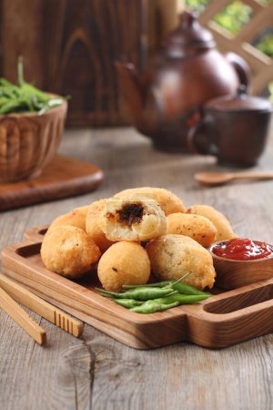 Photo for Comro is a typical Sundanese fritter. Comro is made from grated cassava which is shaped round or oval and filled with chili sauce and chili sauce and fried. - Royalty Free Image