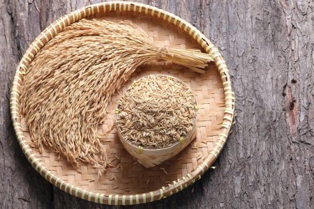 Photo for Dried organic rice in a bowl on a wooden background. - Royalty Free Image