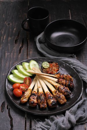 Photo for Sate lilit is a satay variant in Indonesia, originating from Balinese cuisine. This satay is made from minced pork, fish, chicken, beef, or even turtle meat, which is then mixed with grated coconut. - Royalty Free Image