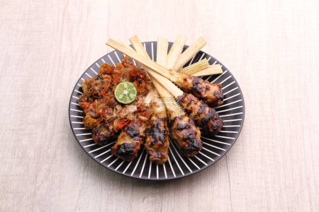 Photo for Sate lilit is a satay variant in Indonesia, originating from Balinese cuisine. This satay is made from minced pork, fish, chicken, beef, or even turtle meat, which is then mixed with grated coconut. - Royalty Free Image