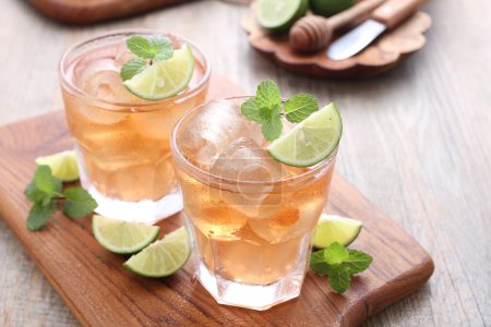 Photo for Fresh ice tea with lime and mint leaves - Royalty Free Image