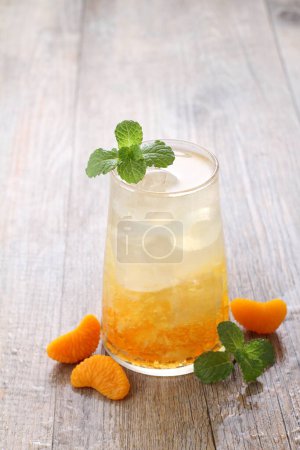 Photo for Ice fresh orange with mint leaf garnish - Royalty Free Image