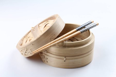 Photo for Chopsticks with bamboo bowl, isolated on white. wooden background. - Royalty Free Image