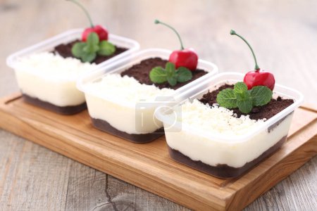 Photo for Homemade fresh and delicious chocolate mousse with cream cheese and strawberries, mint and chia seeds on wooden table - Royalty Free Image