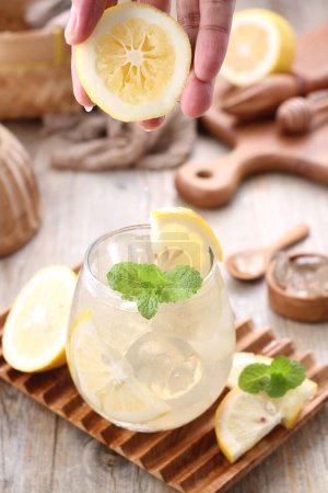 Photo for Lemon juice with mint leaf garnish - Royalty Free Image