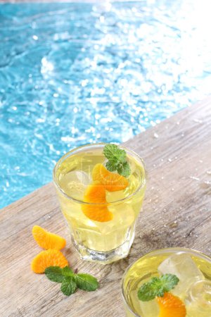 Photo for Ice oranges on the edge of the pool - Royalty Free Image