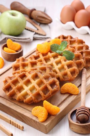 Photo for Waffles with chocolate and honey on a white plate - Royalty Free Image