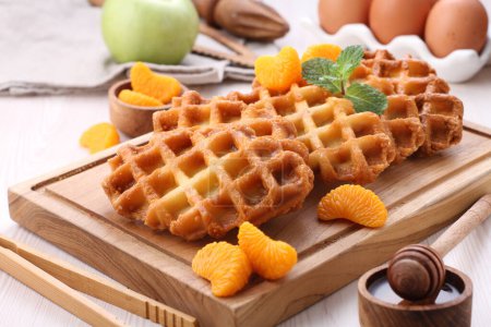 Photo for Waffles with chocolate and honey on a wooden background - Royalty Free Image