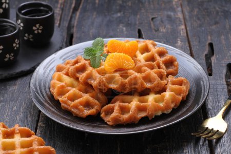 Photo for A waffle is a dish made from leavened batter or dough that is cooked between two plates that are patterned to give a characteristic size, shape, and surface impression. - Royalty Free Image