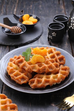 Photo for A waffle is a dish made from leavened batter or dough that is cooked between two plates that are patterned to give a characteristic size, shape, and surface impression. - Royalty Free Image