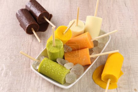 Photo for Homemade popsicles with fruits and berries on wooden background - Royalty Free Image