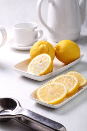 Photo for Lemon and tea on white plate - Royalty Free Image