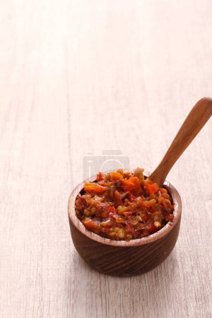 Photo for Red chili pepper in a wooden bowl on a white background - Royalty Free Image