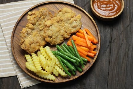 Photo for Chicken breast with potatoes and vegetables on a wooden background - Royalty Free Image