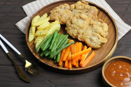 Photo for Close-up of fried fish on plate with vegetables - Royalty Free Image