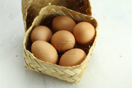 Photo for Eggs in a basket on a white background - Royalty Free Image