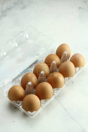 Photo for Eggs in a carton box on a white background - Royalty Free Image