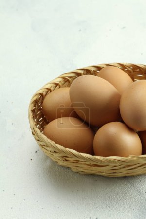 Photo for Eggs in a basket on a white background - Royalty Free Image