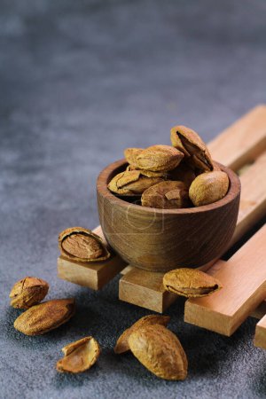 Photo for Bowl of whole almonds on a wooden background - Royalty Free Image