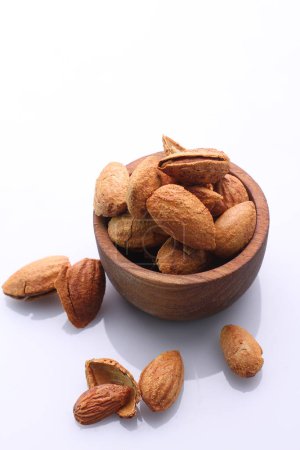 Photo for Almonds in a white bowl isolated on a background - Royalty Free Image