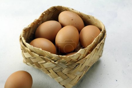 Photo for Eggs in basket on white background - Royalty Free Image
