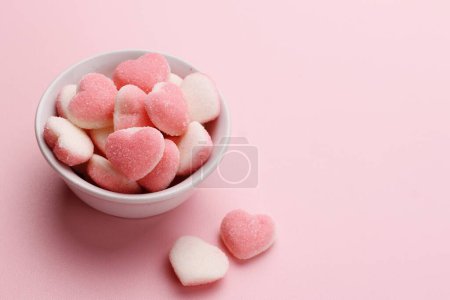 Photo for Pink marshmallows in a heart shape on a black background. - Royalty Free Image