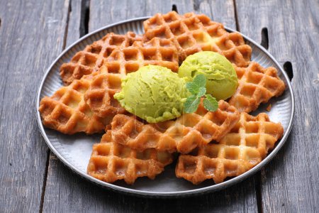 Photo for Waffle waffles with chocolate and mint on wooden background - Royalty Free Image