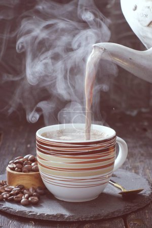 Photo for Coffee cup with steam on wooden background - Royalty Free Image