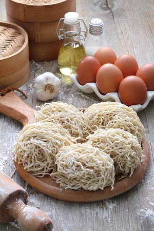 Photo for Raw noodles with flour and vegetables - Royalty Free Image