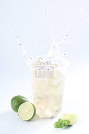Photo for Glass of fresh lime juice with mint on white background - Royalty Free Image