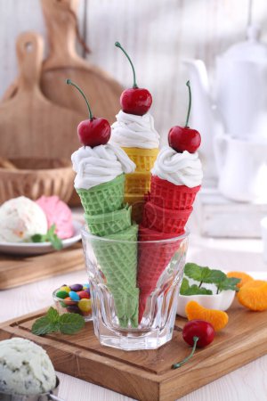 Photo for Ice cream with colorful fruit on wooden table - Royalty Free Image