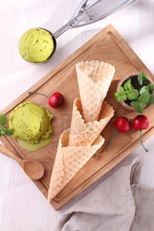 Photo for Fresh ice cream in waffle cone with green mint and mint - Royalty Free Image