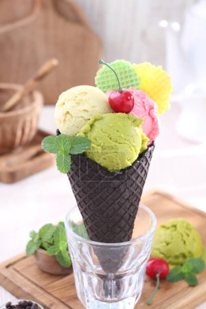 Photo for Delicious ice cream with berries and cones on table - Royalty Free Image