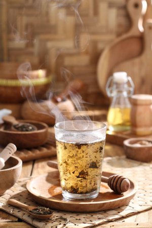 Photo for Tea in a cup on a wooden table - Royalty Free Image