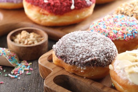 Photo for Colorful donuts on wooden table - Royalty Free Image