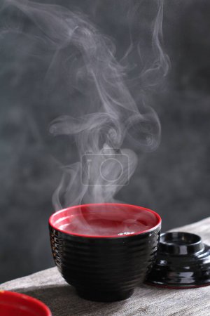 Photo for Black tea in a cup on a wooden table - Royalty Free Image
