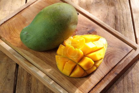 Photo for Fresh and delicious mango fruit on wood background - Royalty Free Image