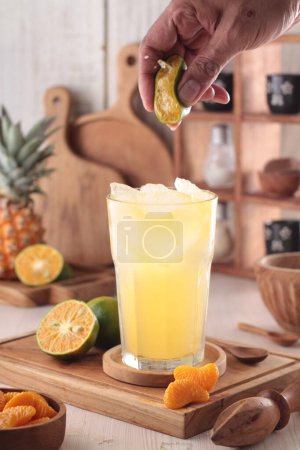 Photo for Fresh pineapple cocktail with lemon and mint on wooden background - Royalty Free Image