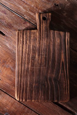 Photo for Wooden cutting board on the wooden table - Royalty Free Image